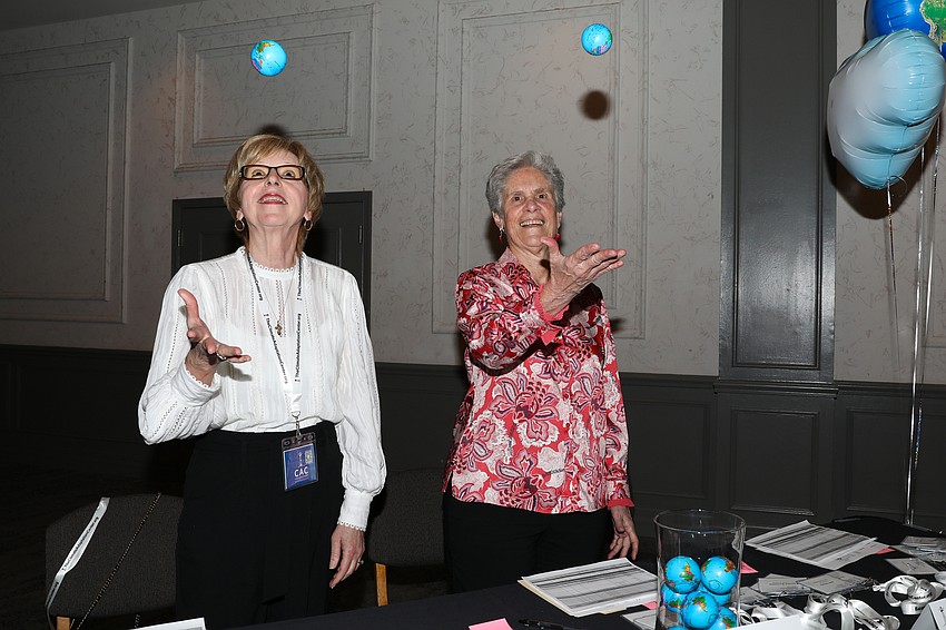 Proving that we do hold the whole world in our hands, CAC's Melanie Ringle and Charlotte Tomanino pass out globe stress balls to arriving guests.