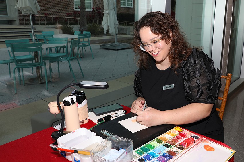 Artist Jennifer Elliott wows the guests with her 'Flash Portraits' that are painted from photos she snaps as guests enter the venue.
