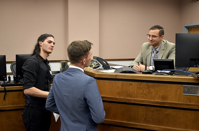 Michel Simon and Hayden Wilding talk with Attorney Patrick Iyampillai, who served as the judge, after a February 2024 session of Teen Court.