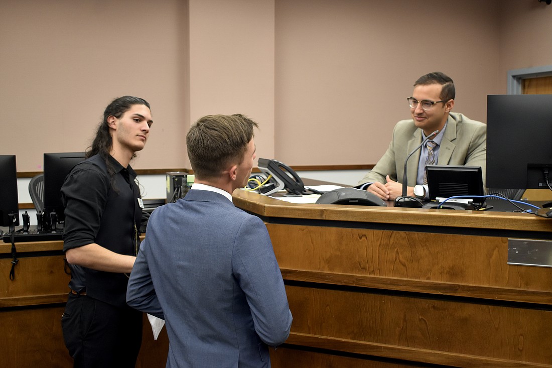 Michel Simon and Hayden Wilding talk with Attorney Patrick Iyampillai, who served as the judge, after a February 2024 session of Teen Court.