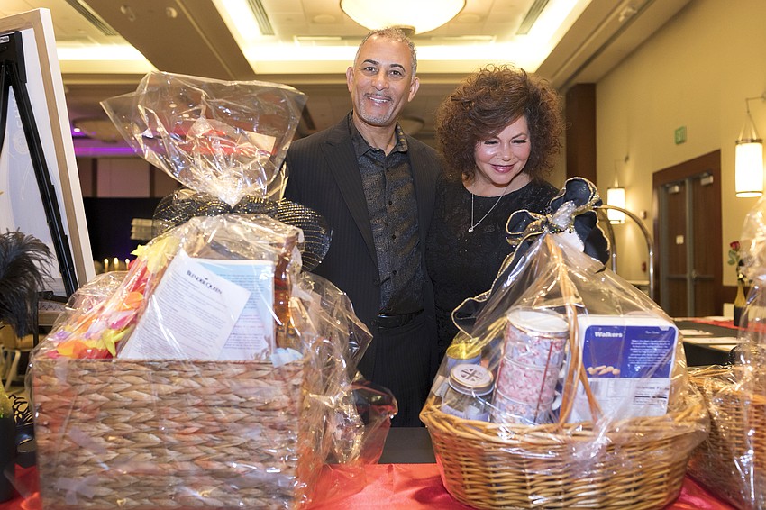 Aric and Carrie Lewis look over the many choices at the silent auction.
