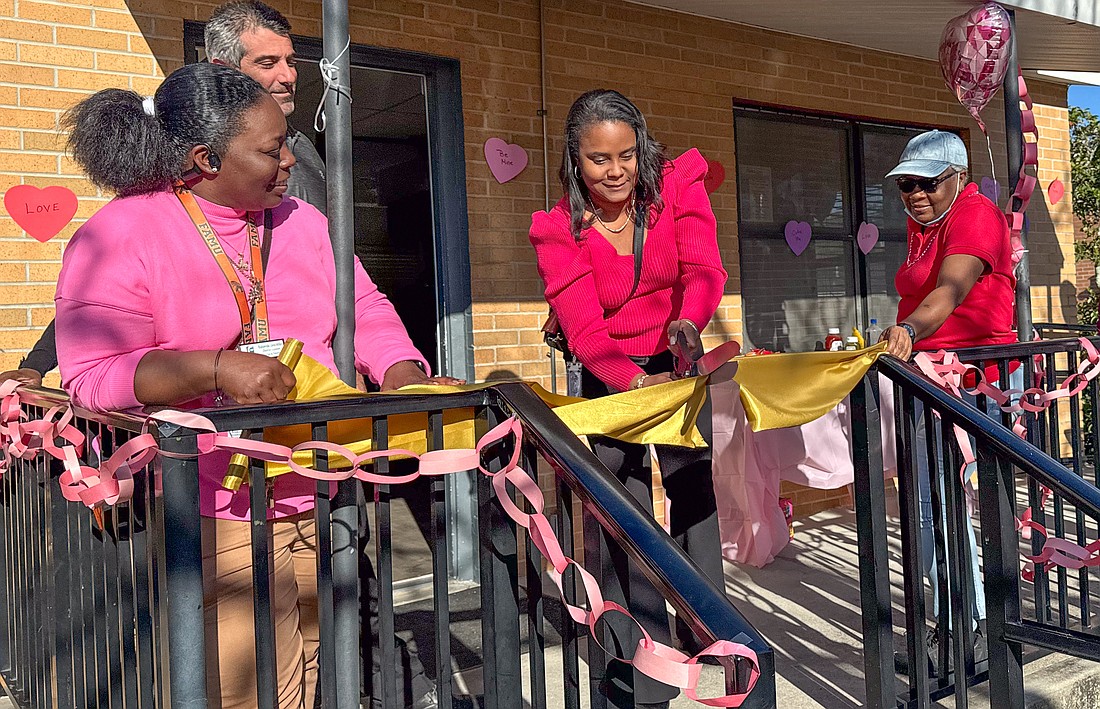 Flagler Schools Superintendent LaShakia Moore (center) cuts the ribbon for the rededication of the Our House Resource Center's 502 South Bacher Street facility in Bunnell. Courtesy photo