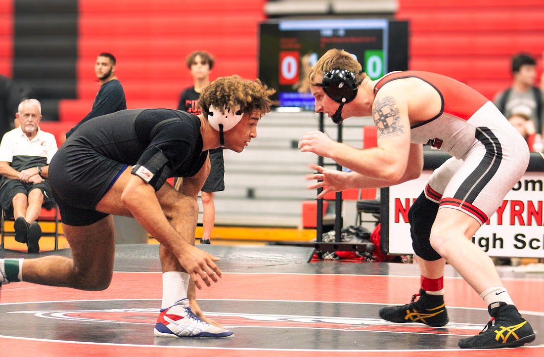 Matanzas senior Jordan Mills faces off with Sawyer VanRider of New Smyrna Beach in the 190-pound final at the District 4-2A tournament. Photo by Rachel and Abe Mills