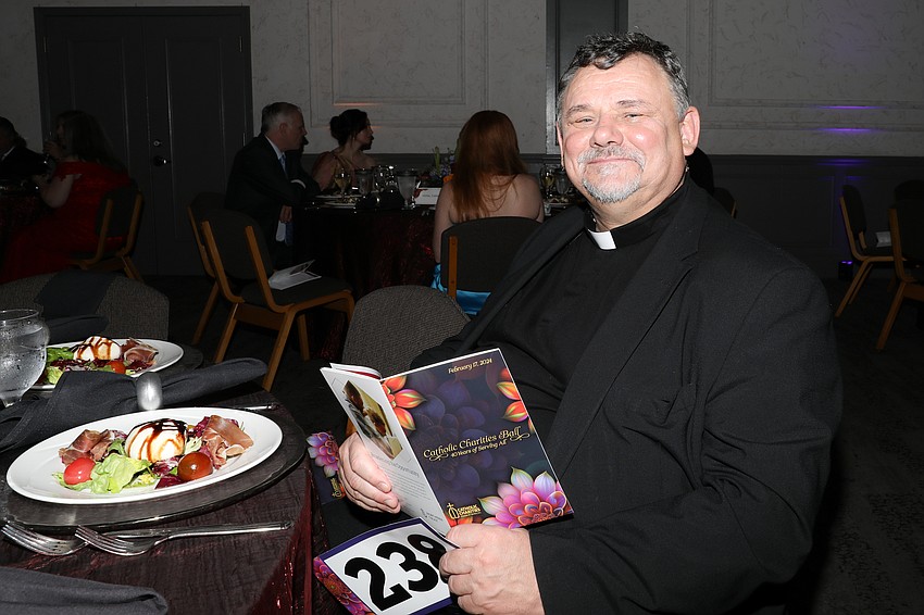 George Suszko from St. Martha's Church prepares to enjoy a deconstructed salad of fresh burrata with sliced prosciutto de parma served on a bed of arugula.