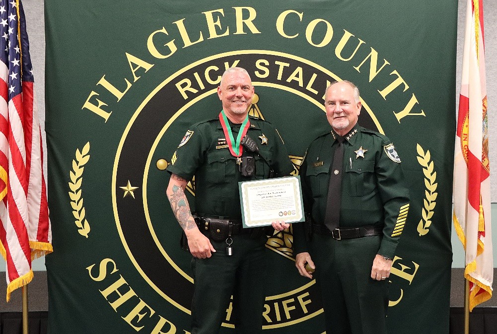Sheriff Staly (right) presents the Life Saving Award to Sergeant Jon Reckenwald (left). Reckenwald was one of eleven recipients of the award. Courtesy of FCSO