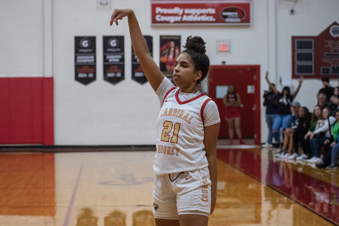 Cardinal Mooney High junior Kali Barrett celebates a made three-point attempt against Tampa Catholic in the regional championship game. Barrett finished with 27 points.