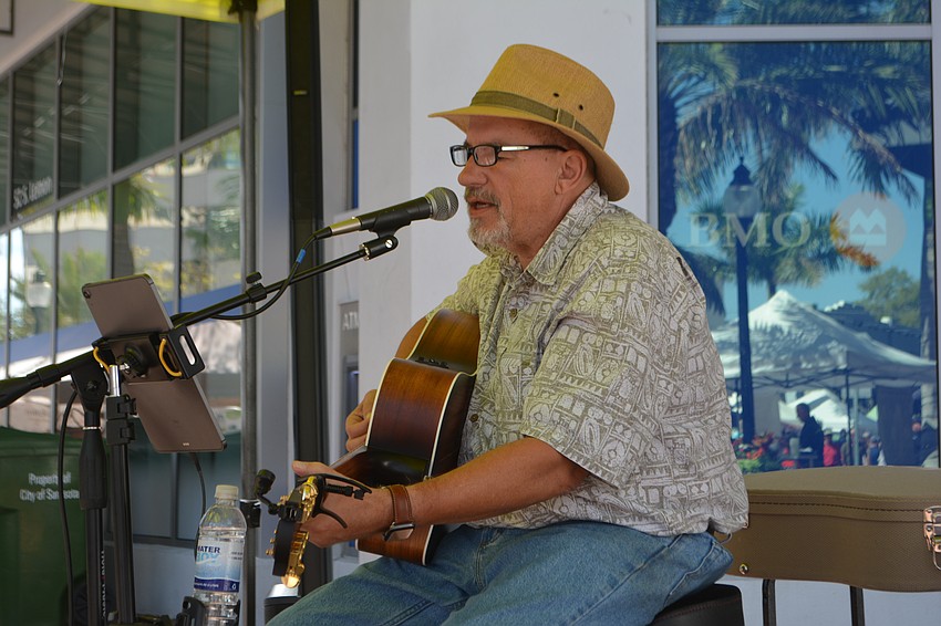 Guitarist Dave Miner sings at the Sarasota Farmers Market.