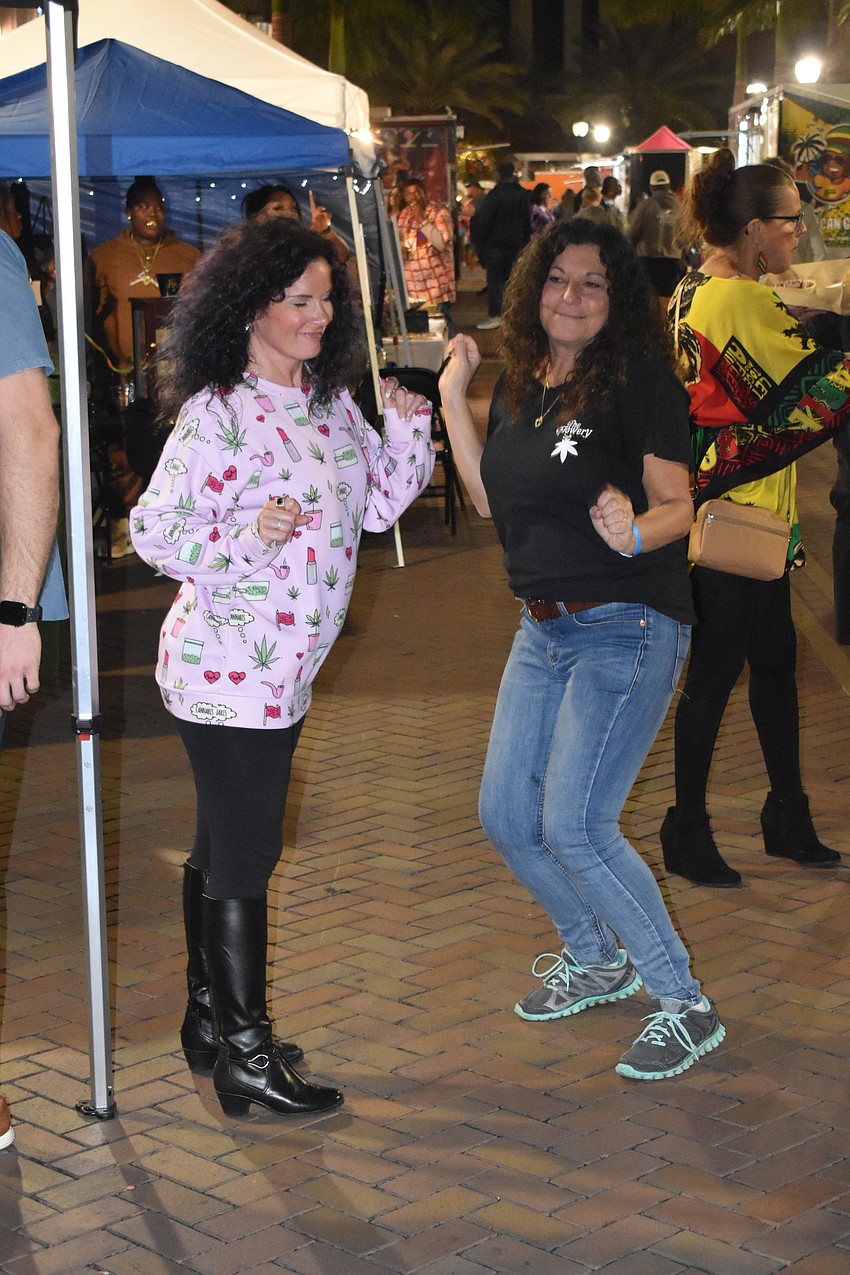 Nancy Cason and Josephine Cannella-Krehl dance to the music.