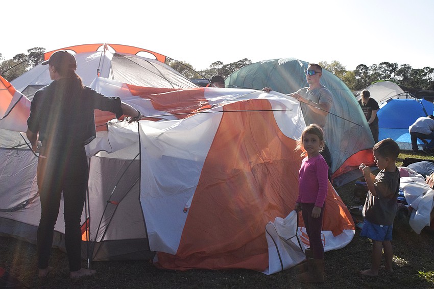 Lakewood Ranch's Nicole Thidbodeau and her husband, Phil Thibodeau, get help putting up the tent from their 5-year-old daughter Zolana and 4-year-old son Dexon.