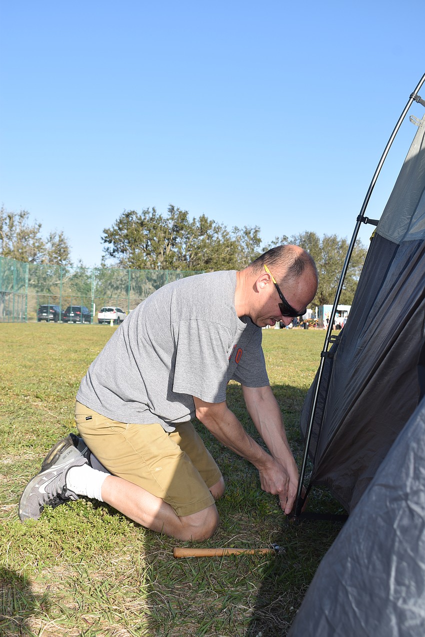 Lakewood Ranch's Nick Sutera pitches his tent. Although it's his second year at the Community Campout, he said he's still a novice when it comes to putting up his tent. 