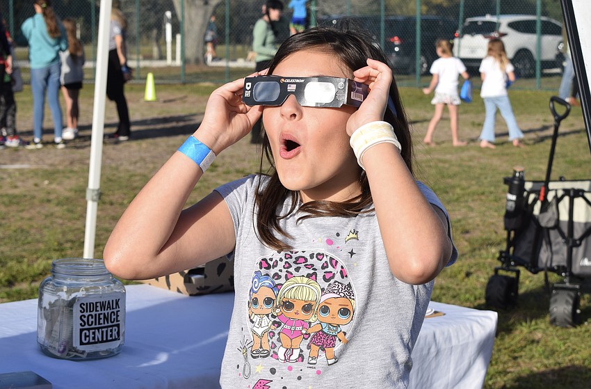 Greenbrook's Katerina Vergnais tries on a pair of solar eclipse glasses. 