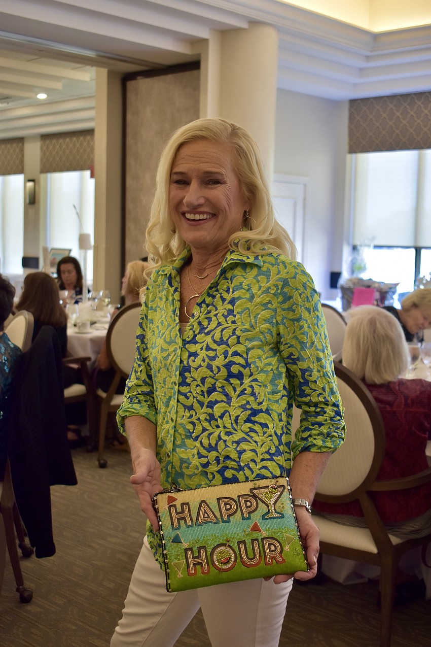 Kay Kwenski is ready for happy hour with this colorful clutch bag. Her button down shirt is by David Cline.