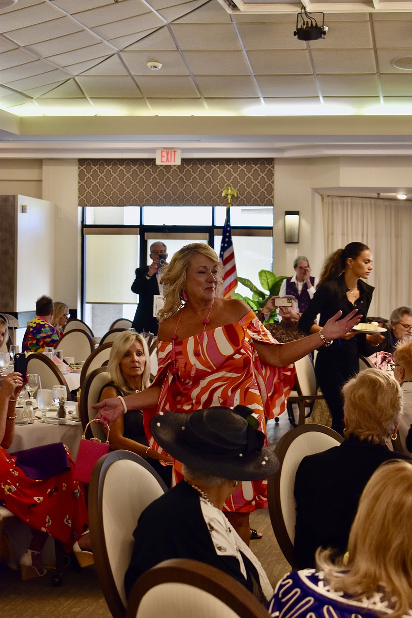 Kathy Matheson spins for the crowd in an off-the-shoulder dress.