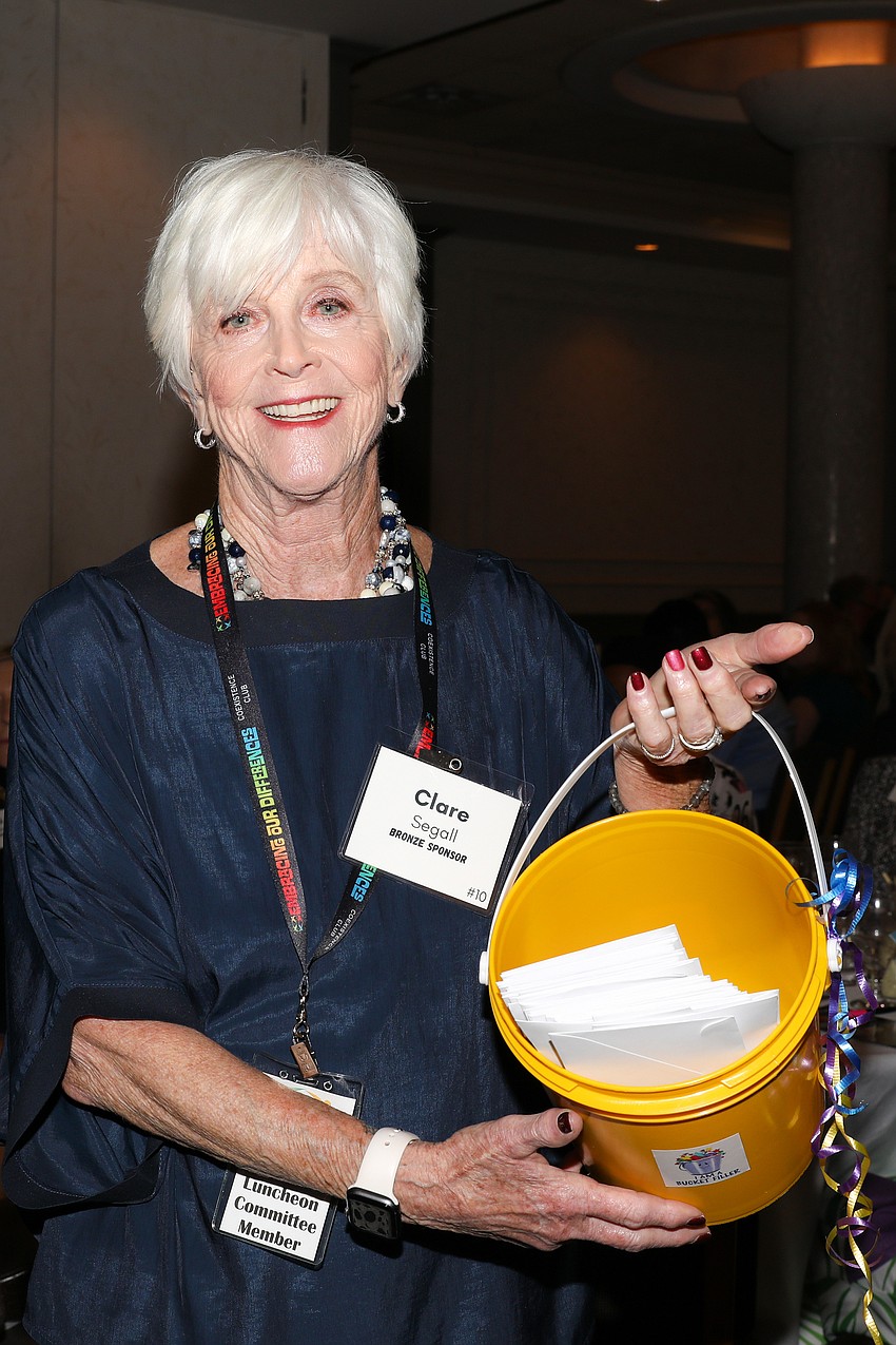 Volunteer Clare Segall collects donations during the Embracing Our Differences luncheon.