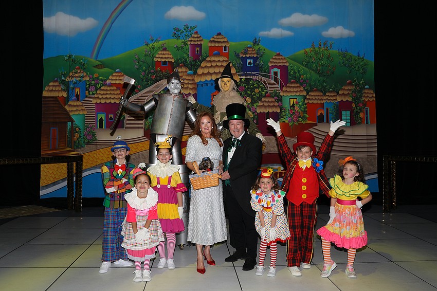 From Cirque Vertigo are the Tin Man Aydar Rakhmatullin,  Cowardly Lion Roma, Cooking for Wishes Co-Chair Terri Klauber with Luna staring as Toto, emcee Michael Kaluber, and performers Braden Baker, Faith Marie, Ainsley McLaughlin, Steffi Goldstone, Lincoln Rhoades and Farrah Moreno