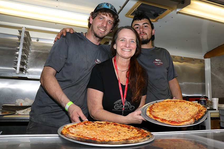 Robert Riley, mom Marcia Goldstein, and Sean Fultz with their sought-after pizza pies.