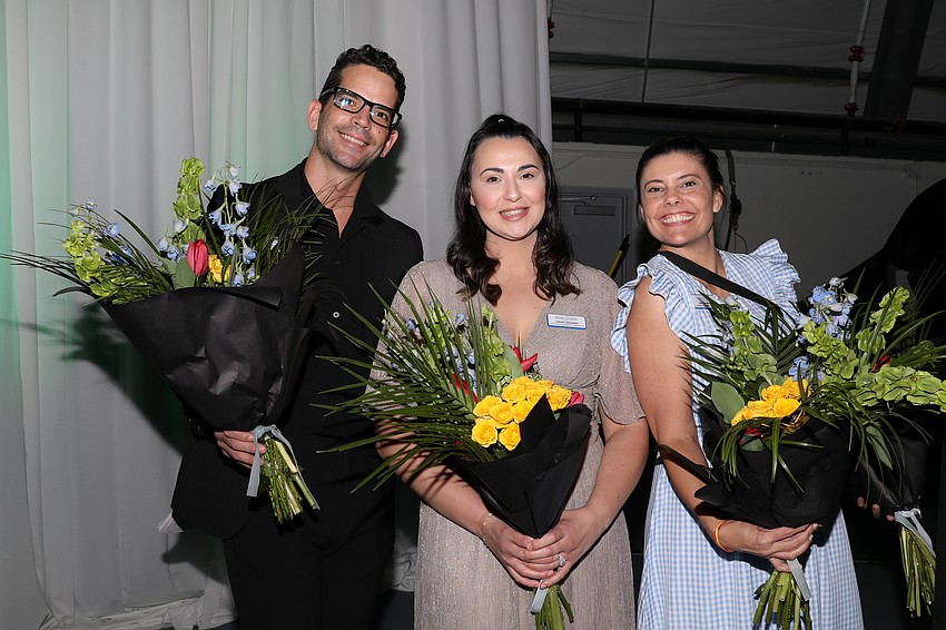 Miguel Medina, Lindsey Demarest and Emily Rickerson get ready to present flowers to the co-chairs.