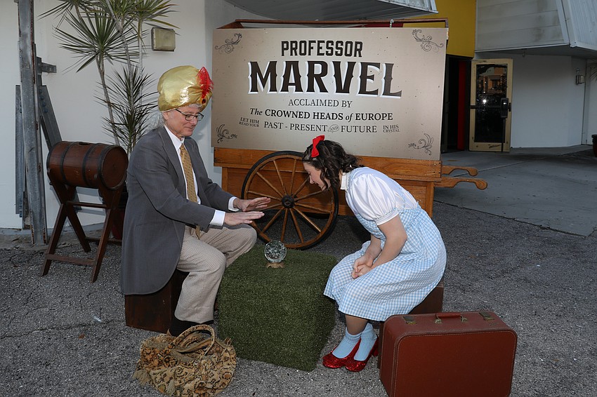 Howard Kleinfeld and Lila Watkins use a crystal ball and predict fair winds and a successful event as Professor Marvel (aka The Wizard) and Dorothy.