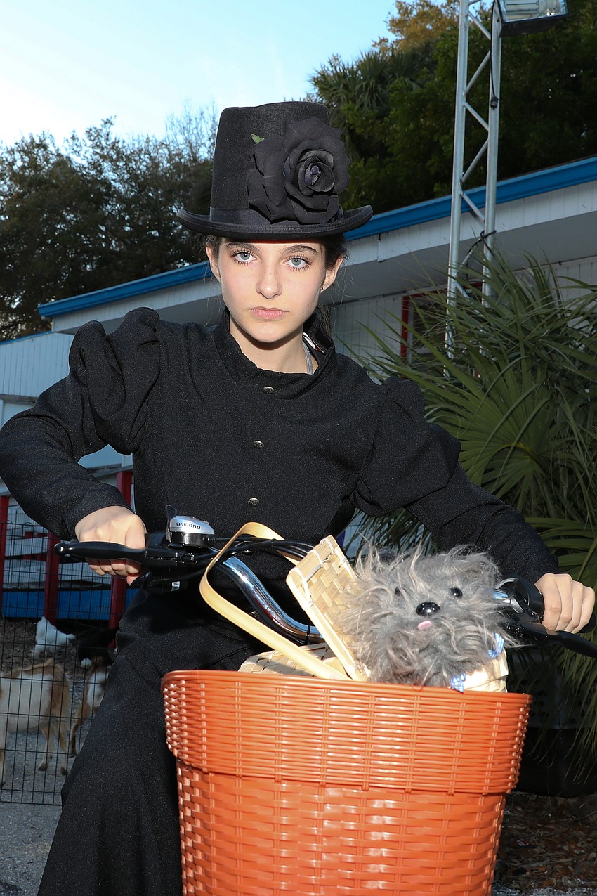 Booker High School student Gina Rose Masarik, 15, enjoys a side-hustle performing as Miss Gulch, aka, The Wicked Witch of the West