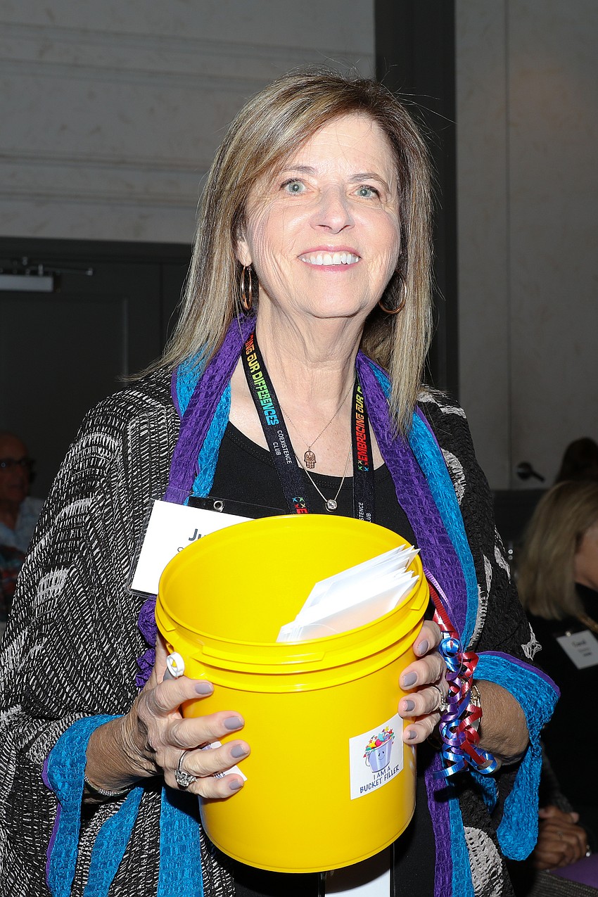 Volunteer Jude Schwartz collects donations during the Embracing Our Differences Luncheon.