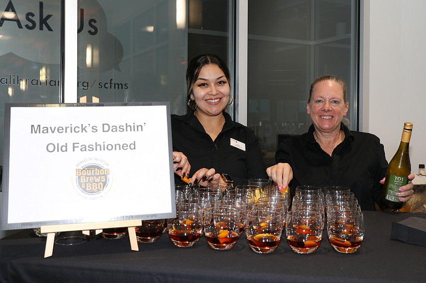Pier 22 staff Trish Martinez and April Conner serve old fashioned drinks