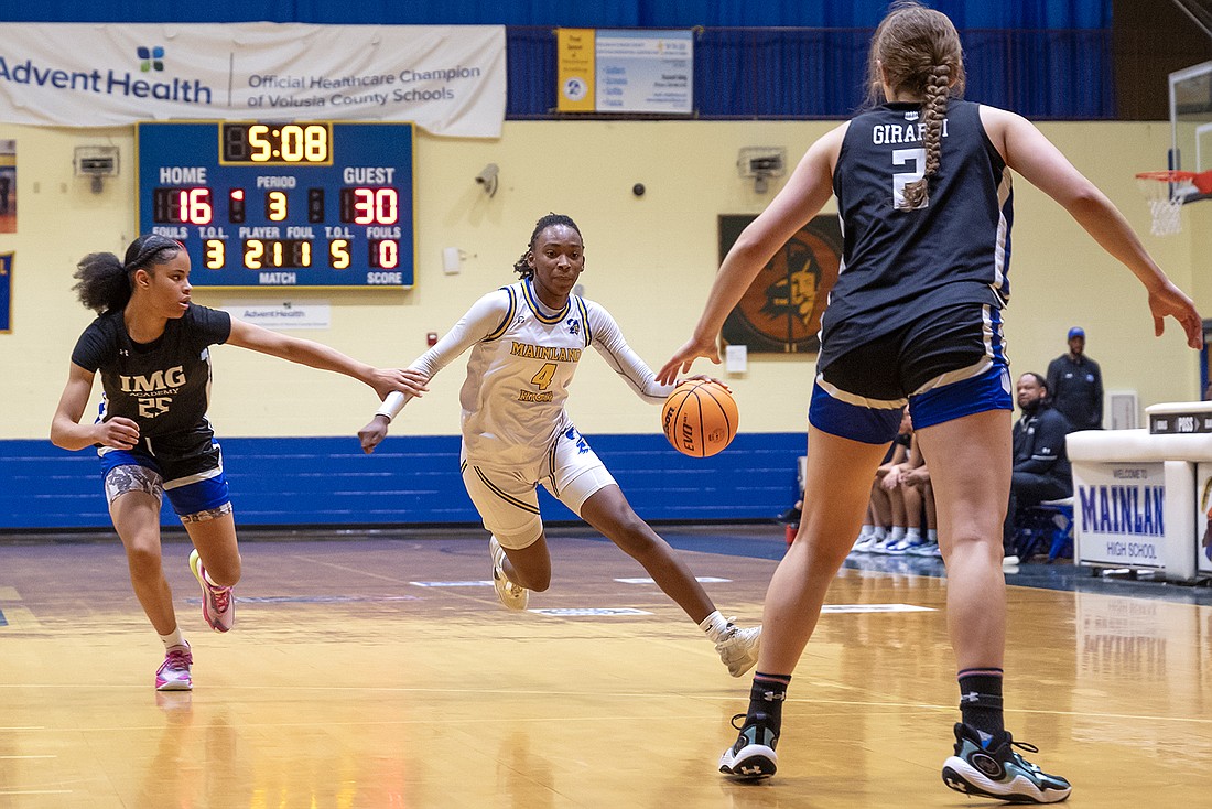 Anovia Sheals (4) dribbles through traffic in a game earlier this season against IMG Academy. File photo by Michele Meyers