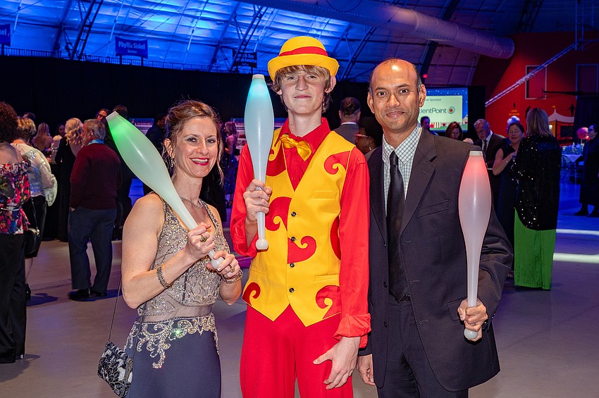 Honorary Chairs Elizabeth Guancial and Pavan Tandra with Circus Arts student Anton Deev (center)
