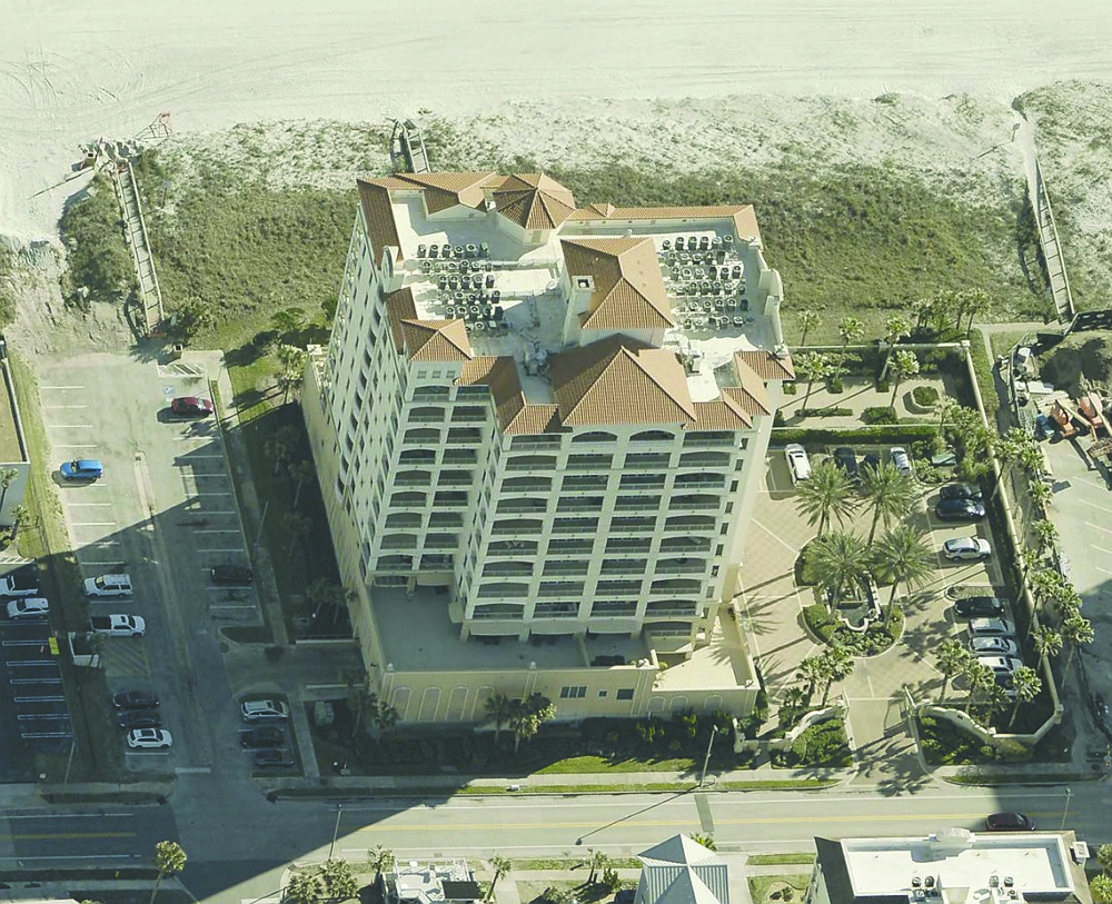 Oceanfront condominium features four bedrooms, four bathrooms, terrace, outdoor kitchen, two-car garage spaces, community pool and exercise room.