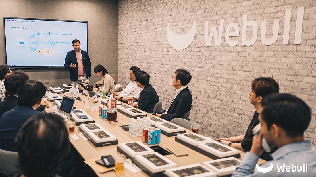 Anthony Denier, Webull CEO, speaks to company partners from Japan and Singapore. Webull, with major operations in St. Pete, will merge with a "blank check" investor already listed on Nasdaq and will become the lead company.