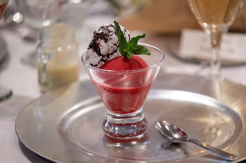 Guests enjoy a dessert of mint cringle cookie with raspberry sorbet