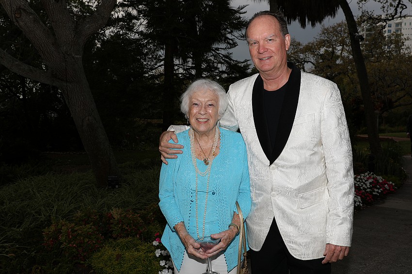 A beaming Carol Hochberg arrives on the arm of her son, Craig McLeod
