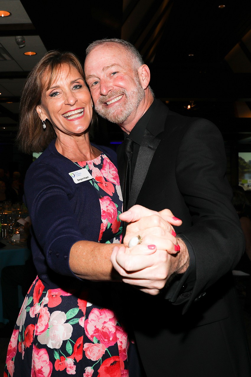 Georgann Nugent and Jeffery Kin cut some rug.