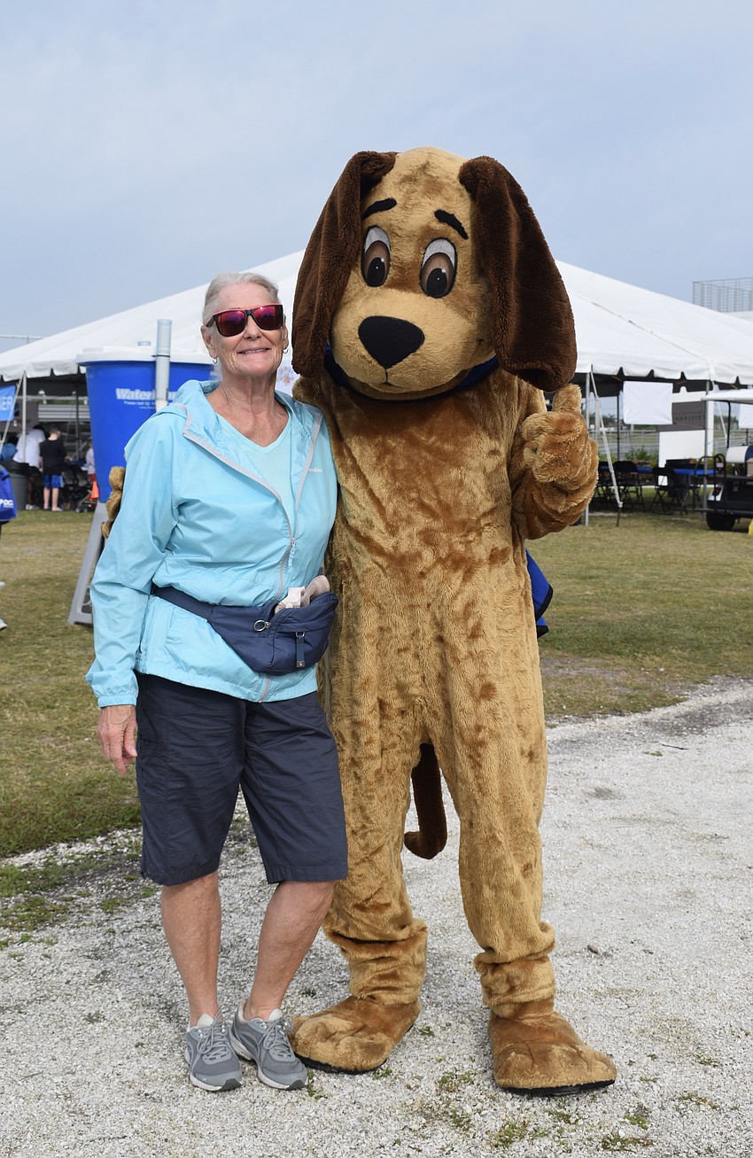 Palmetto's Monique Marlow and Scout, the mascot for Southeastern Guide Dogs, are ready to walk around Nathan Benderson Park for the nonprofit's annual walk-a-thon. 