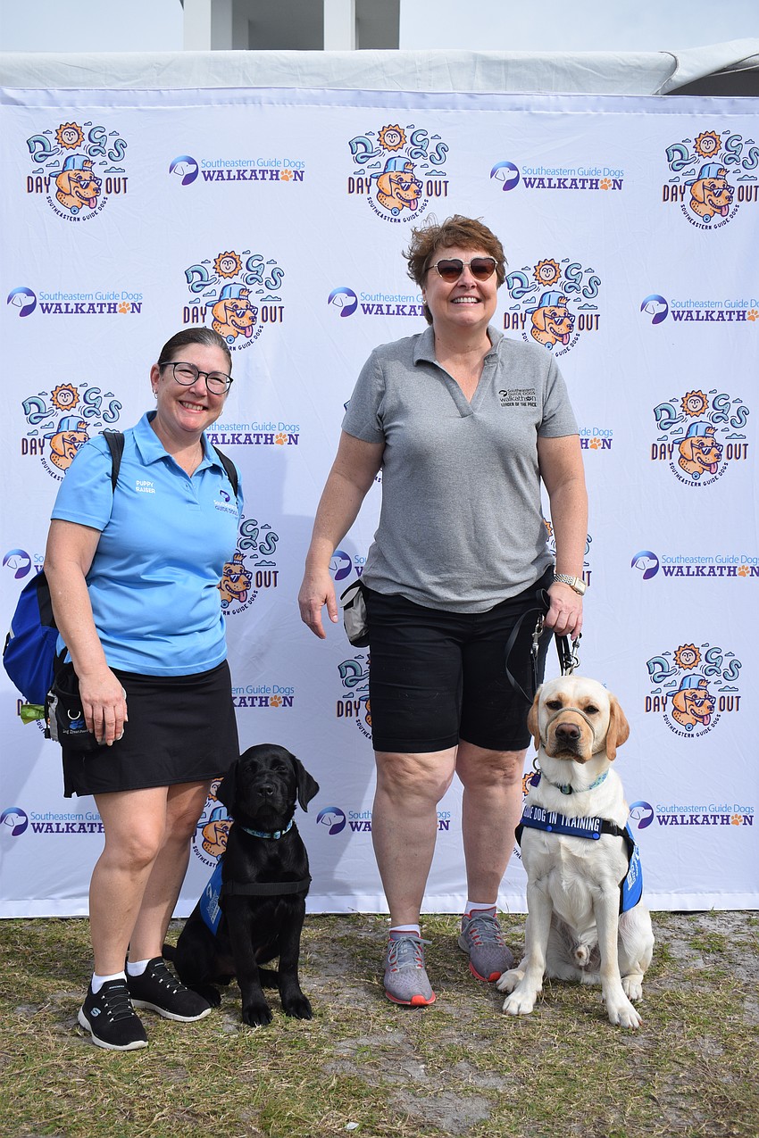 Puppy raisers Maria Abelleira and Colleen Flaherty, of Parrish, love taking care of Blue, a 4-month-old dog, and Dispatch, a 15-month-old dog, before they go for training at Southeastern Guide Dogs.
