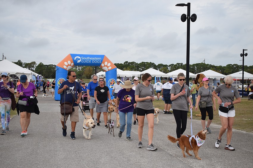 Dozens of people and their four-legged friends begin the 3K walk.
