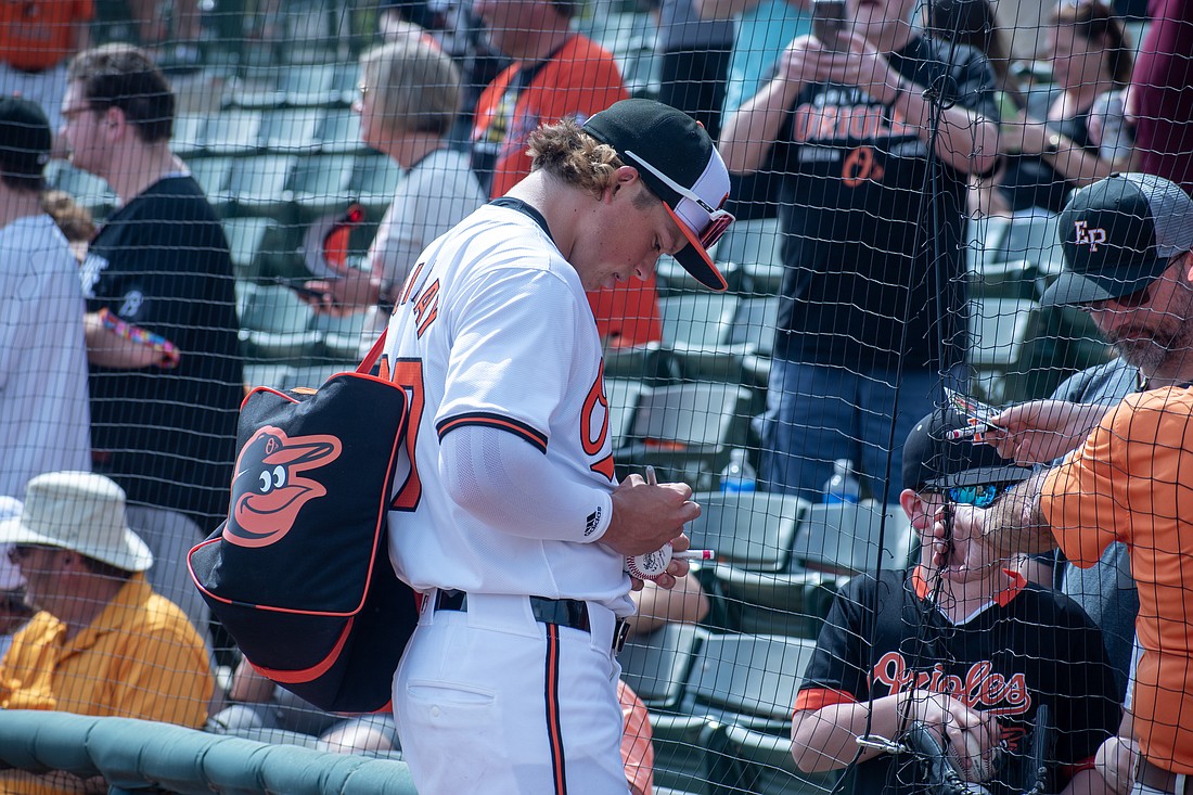 Jackson Holliday signs autographs for fans at Ed Smith Stadium before the Baltimore Orioles' Feb. 29 game against the Pittsburgh Pirates.