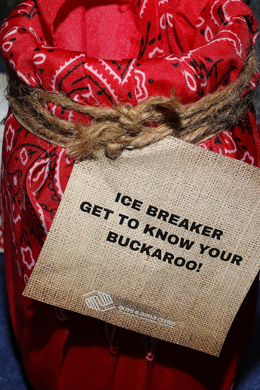 Centerpieces included western themed decked out canning jars filled with ice breaking questions that were used for guests and children to interact with each other.