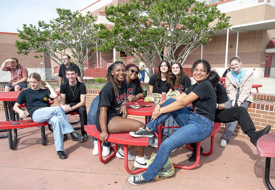 Family and friends sit in the courtyard at Seabreeze High School listening to the SHS Jazz Band perform during the World Languages Festival. Photo by Michele Meyers