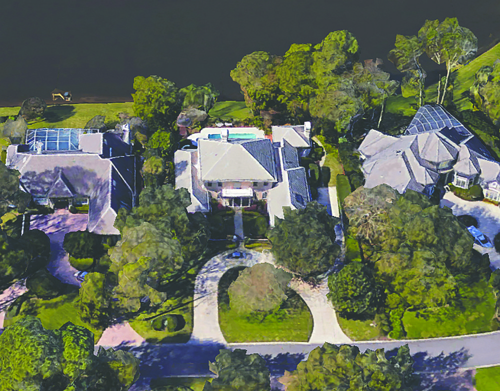 Lakefront two-story home in the Plantation at Ponte Vedra features five bedrooms, seven full and one half-bathrooms, two offices, exercise room, balcony, porch and patio, pool, outdoor kitchen and three-car garage.