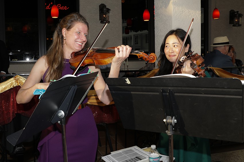 Anne Chandra and Cy Hong entertain with their violin prowess; they are known collectively as Prometheus Duo