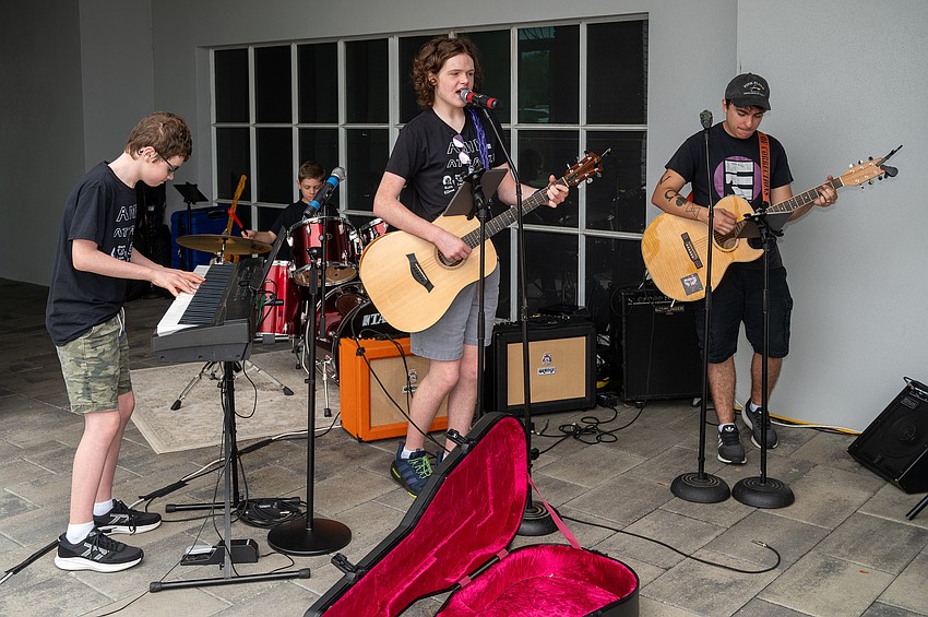 The band Everyone Rocks plays at the entrance to welcome guests.
