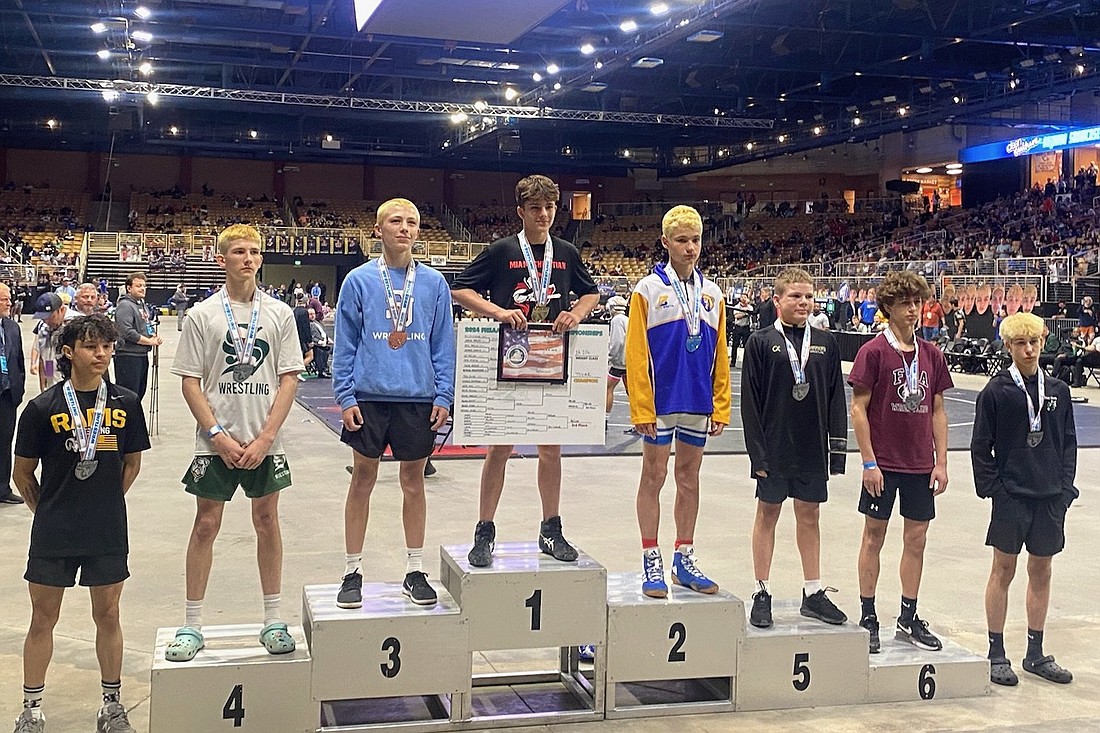 Kevin McLean of Palm Coast (third from left) stands on the podium after placing third at 106 pounds in the Class 1A state wrestling championships. Courtesy photo