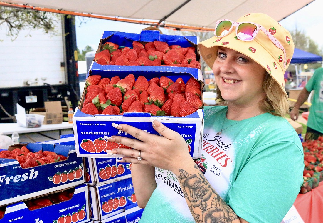 Alexa Gilbert shows off the strawberries at the festival. The strawberries at the Strawberry Festival were from Pablo & Sons Farms in Plant City, Florida. Photo by Sierra Williams