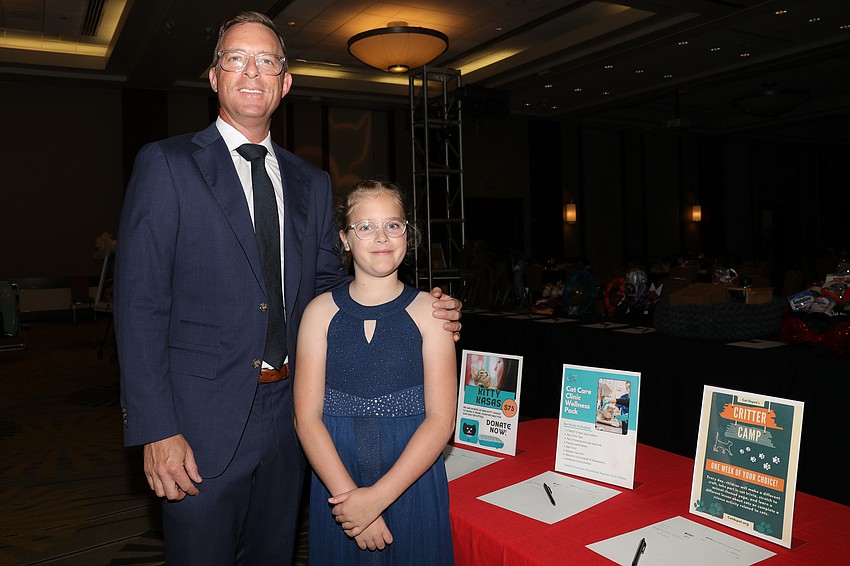 Elliott Bell, 8, is proud that she and her dad, Michael, have offered up a matching gift at the gala for Cat Depot.