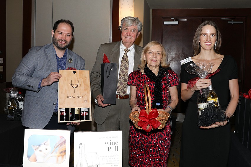 Jeff Kaufman, George and Linda Mitchell, and Jessica Carlson manage the wine pull.