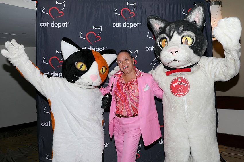 Petunia and Callie pose with Maria Herrera who adopted her 