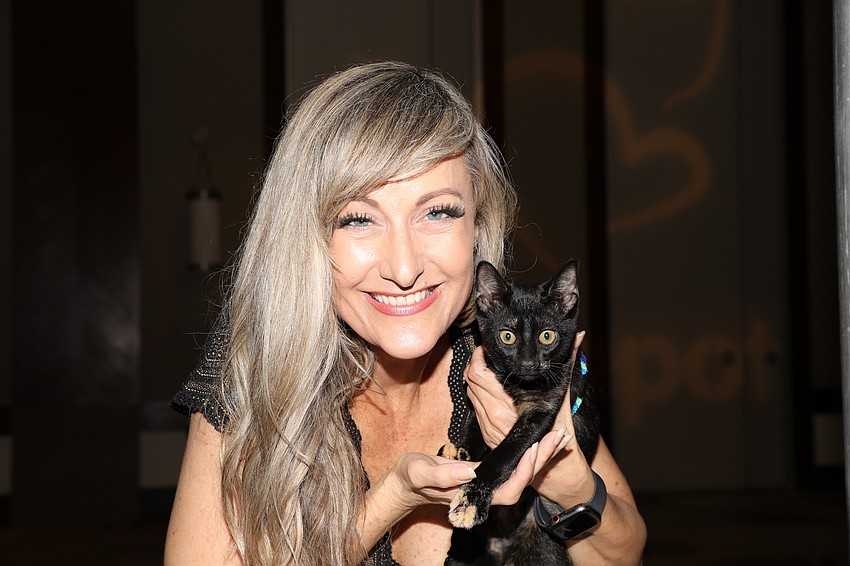 Kirsten Sponseller, with Noel, is the emcee for the Cat Depot Gala held on March 7.