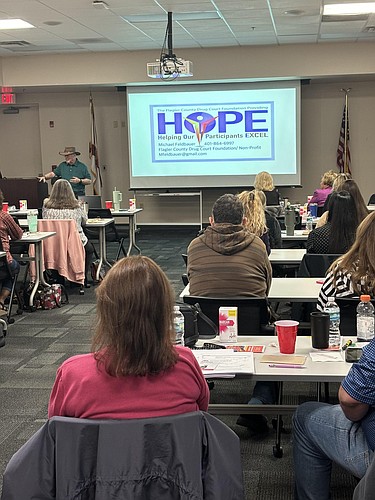 Flagler County Drug Court Foundation President Michael Feldbauer leads a Narcan training session with county Tax Collector's Office personnel on Feb. 19 at the county's Emergency Operations Center. Courtesy photo