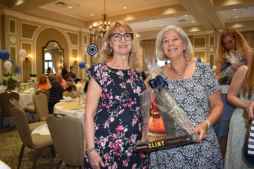 Teresa Ramallo and Lynne Godofsky attend Divas and Dogs on March 15. Godofsky is leaving with a silent auction prize.