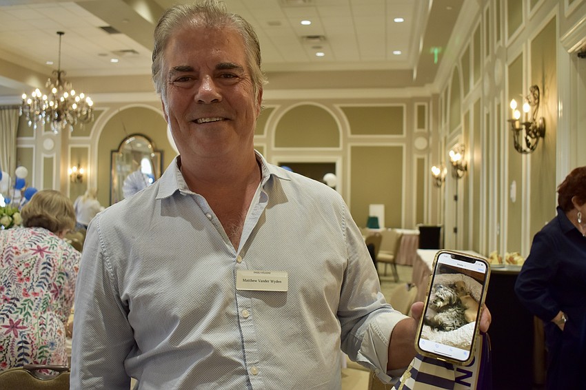 Matthew Vander Wyden shows off a picture of his dog Coco.